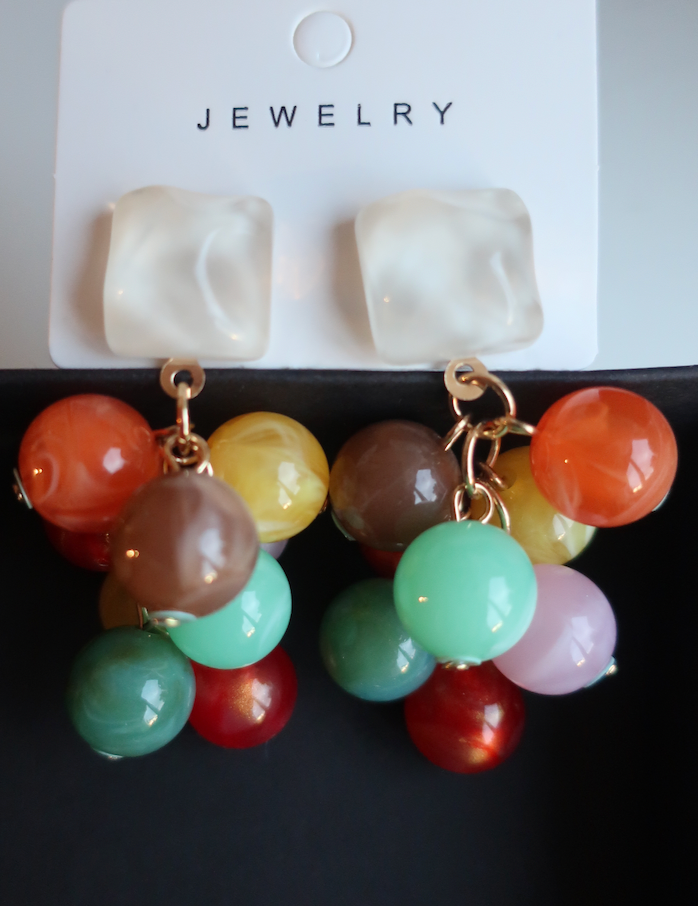 Colorful stone cluster earrings on display
