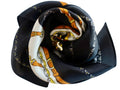 Black fabric flower with a patterned center on a light gray background