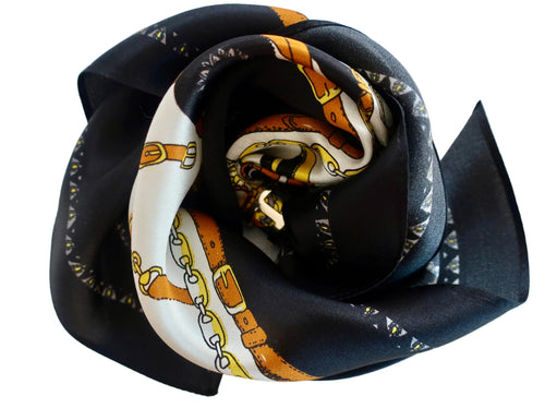 Black fabric flower with a patterned center on a light gray background