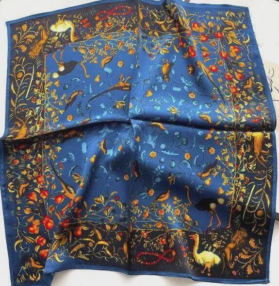 Decorative blue fabric with intricate patterns and colors on a white background