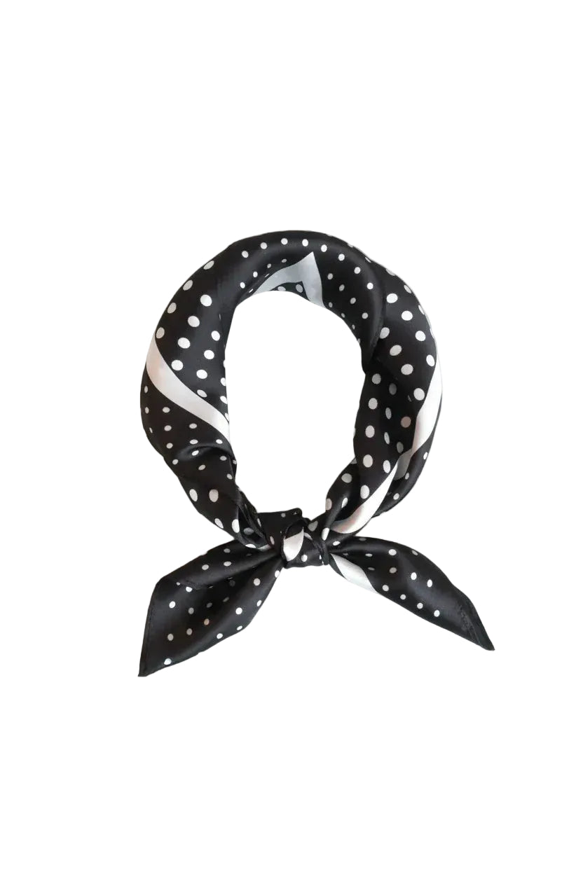 Black and white polka dot scarf on a light gray background