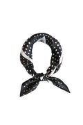 Black and white polka dot scarf on a light gray background