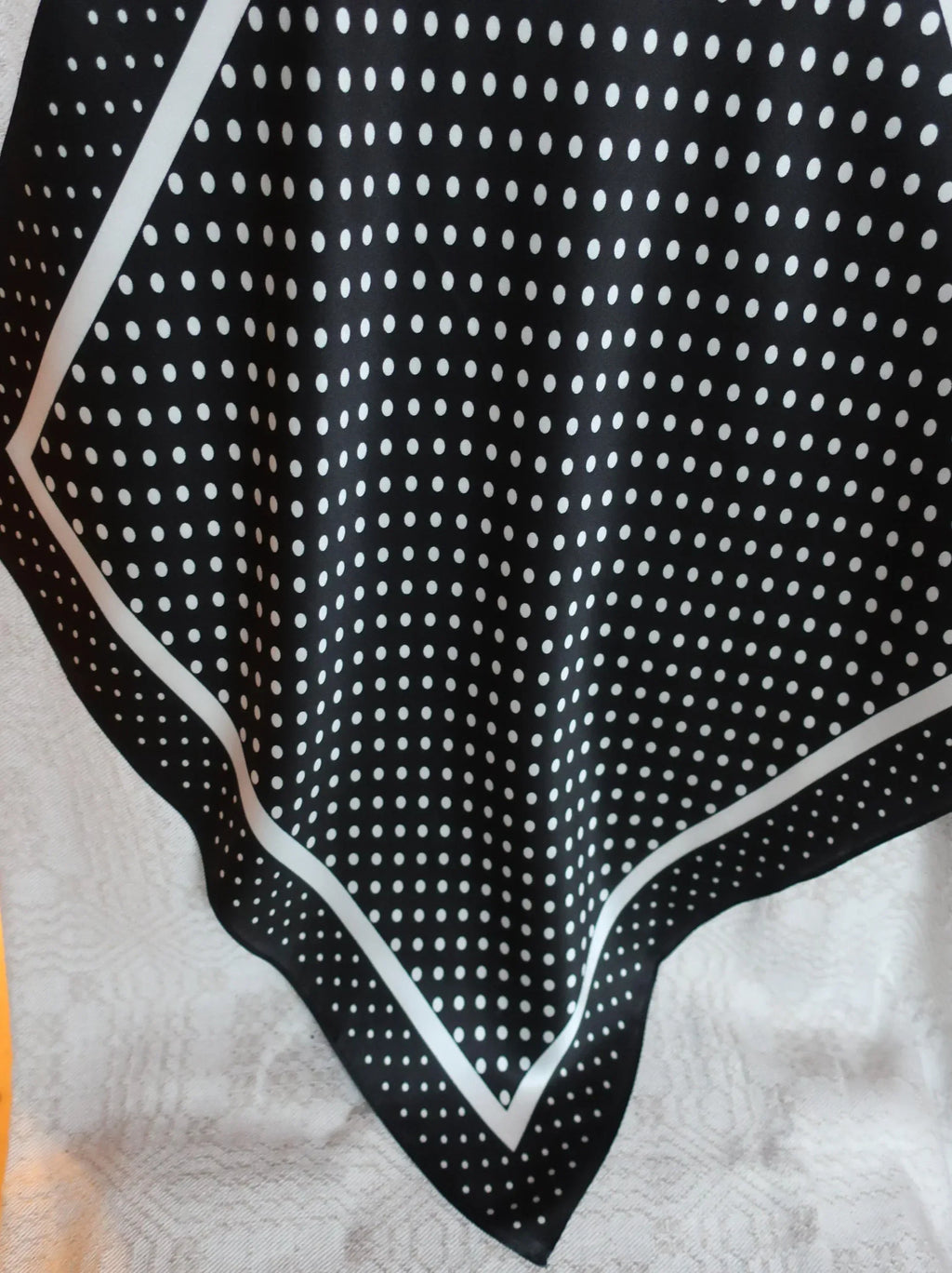 Black and white polka dot fabric on a white background