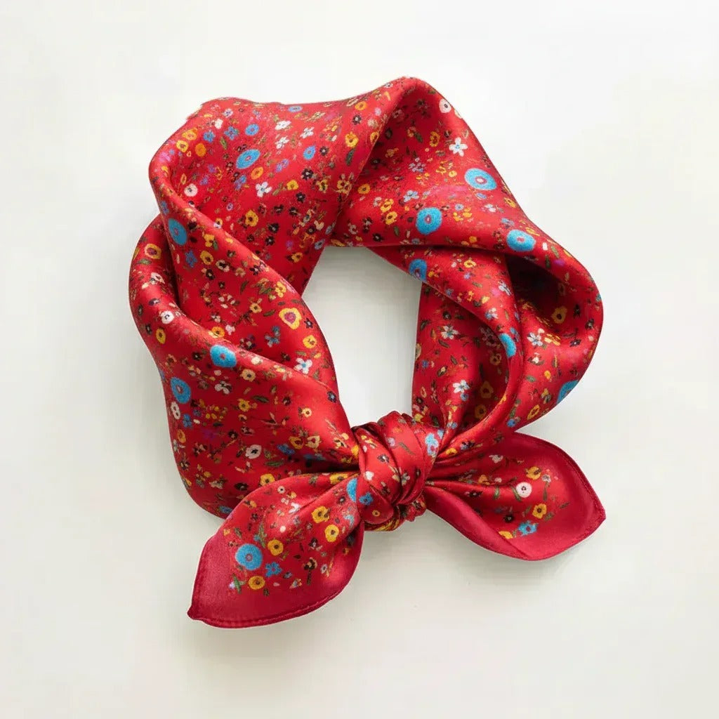 Red floral patterned scrunchie on a white background