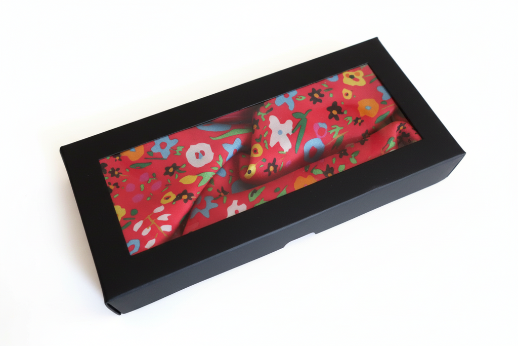 Floral-patterned headband in a black box on a white background