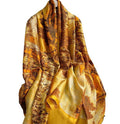 yellow patterned scarf in a garden settingon a white background
