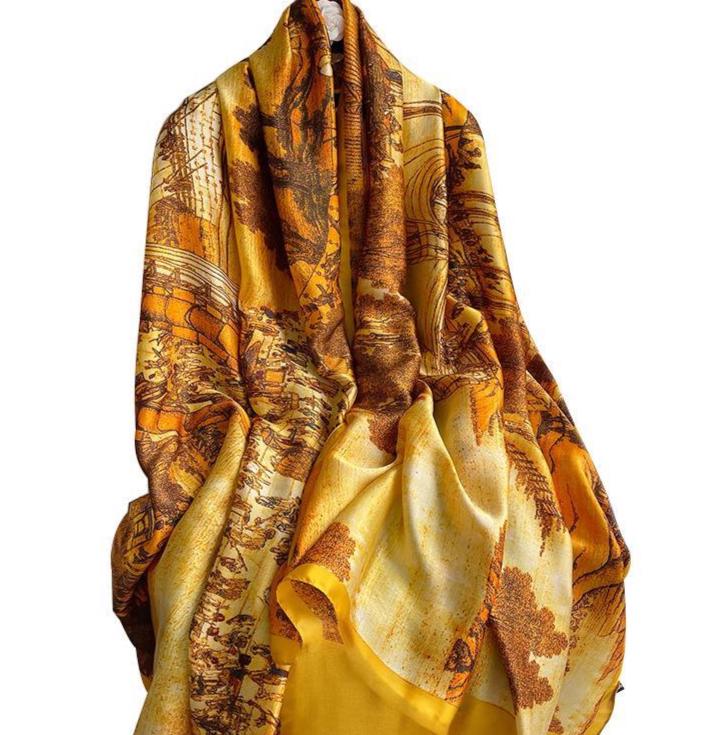 yellow patterned scarf in a garden settingon a white background